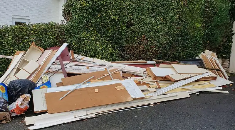 Pile of timber, boards and offcuts from building work on a driveway